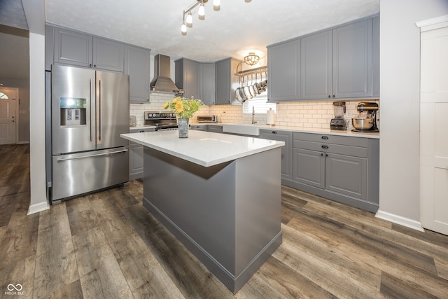 14126 Stonewood Pl, Fishers, IN 46037 - kitchen featuring stainless steel appliances, gray cabinetry, wall chimney range hood, and tasteful backsplash