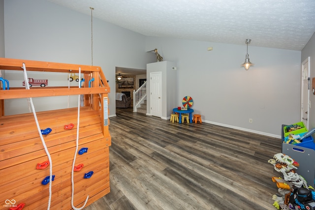 14126 Stonewood Pl, Fishers, IN 46037 - playroom with vaulted ceiling, wood finished floors, and a textured ceiling