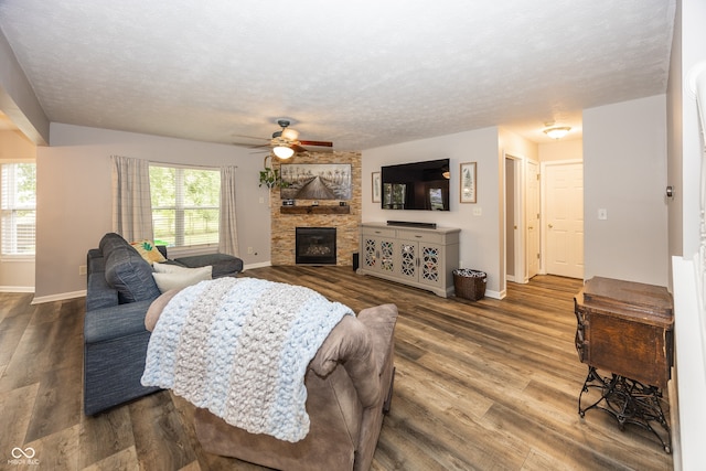 14126 Stonewood Pl, Fishers, IN 46037 - living room with a ceiling fan, a large fireplace, dark wood-style flooring, and a textured ceiling