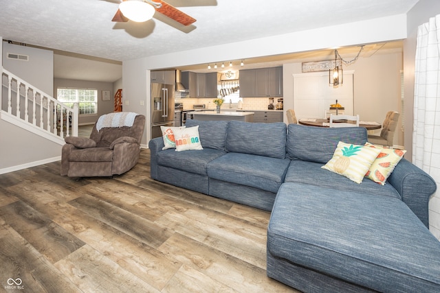 14126 Stonewood Pl, Fishers, IN 46037 - living area with wood finished floors, ceiling fan, and stairs