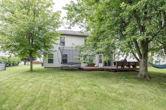 14126 Stonewood Pl, Fishers, IN 46037 - back of property featuring a trampoline, a deck, and a lawn