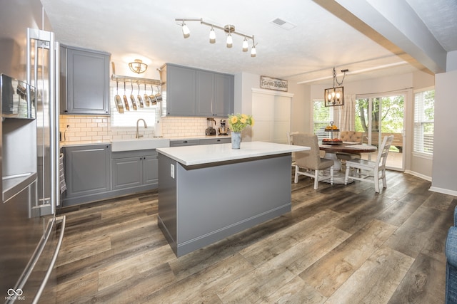 14126 Stonewood Pl, Fishers, IN 46037 - kitchen with gray cabinetry, high quality fridge, light countertops, tasteful backsplash, and a center island