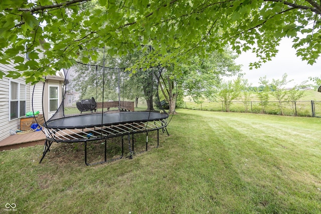 14126 Stonewood Pl, Fishers, IN 46037 - fenced backyard with a trampoline and a wooden deck