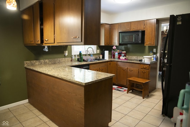 124 Georgton Ct, West Lafayette, IN 47906 - kitchen with black appliances, a peninsula, light tile patterned flooring, brown cabinetry, and light stone counters