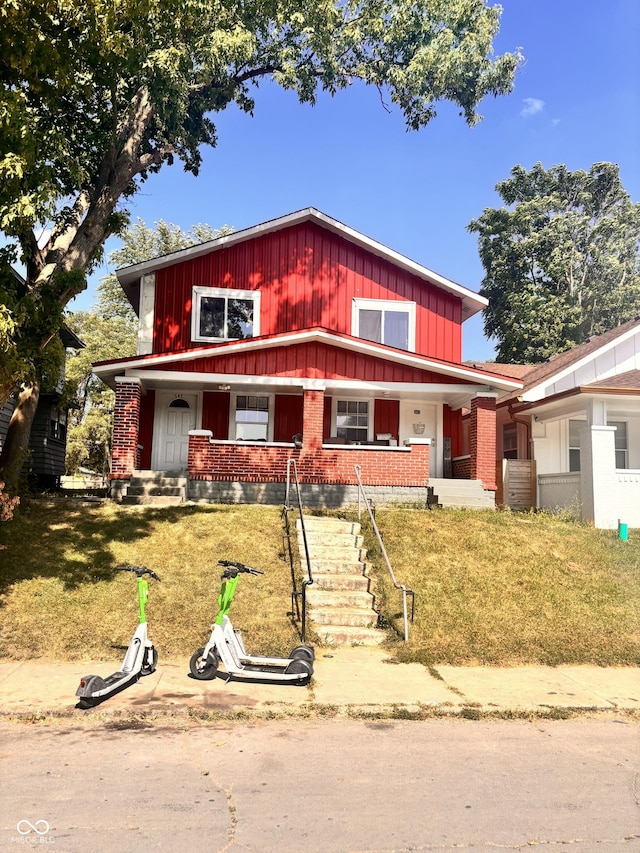 543 N Oakland Ave, Indianapolis, IN 46201 - view of front of property with brick siding, a porch, and board and batten siding