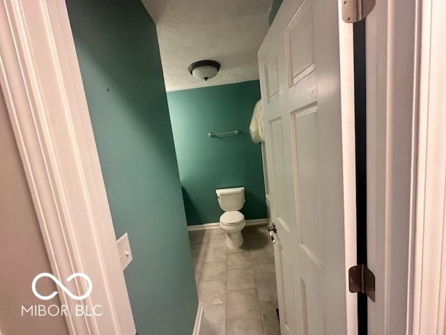 9490 N Keith Dr W, Columbus, IN 47203 - bathroom with a textured ceiling and tile patterned flooring