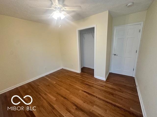 9490 N Keith Dr W, Columbus, IN 47203 - unfurnished bedroom featuring dark wood-style floors, a closet, a ceiling fan, and a textured ceiling