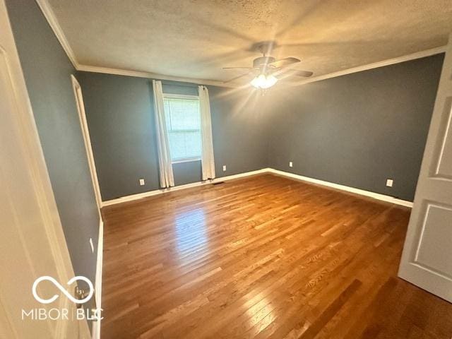 9490 N Keith Dr W, Columbus, IN 47203 - unfurnished room featuring crown molding, wood finished floors, a ceiling fan, and a textured ceiling