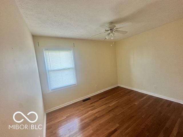 9490 N Keith Dr W, Columbus, IN 47203 - unfurnished room with ceiling fan, dark wood-style floors, and a textured ceiling