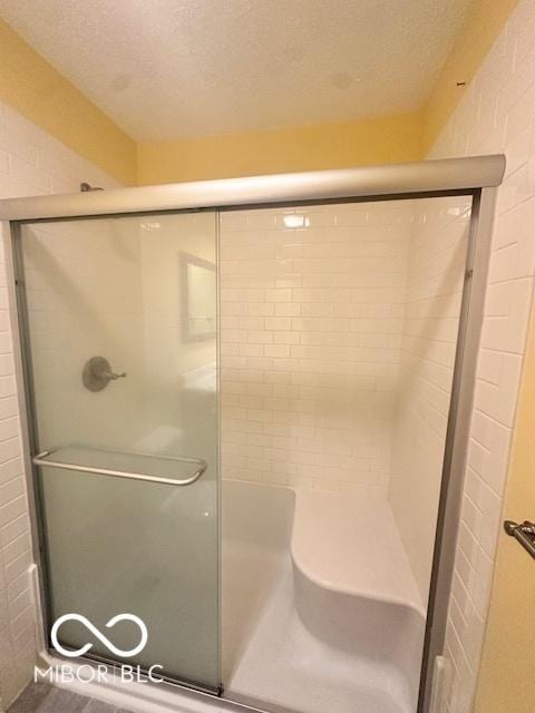9490 N Keith Dr W, Columbus, IN 47203 - bathroom featuring a shower with shower door and a textured ceiling