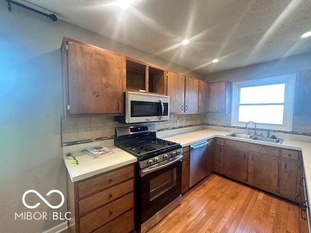 9490 N Keith Dr W, Columbus, IN 47203 - kitchen featuring stainless steel appliances, light countertops, decorative backsplash, and recessed lighting