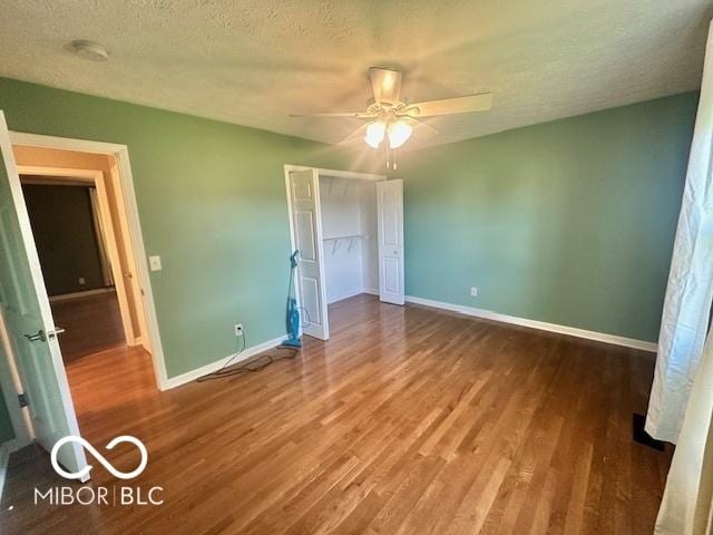 9490 N Keith Dr W, Columbus, IN 47203 - unfurnished bedroom with wood finished floors, a closet, a textured ceiling, and ceiling fan