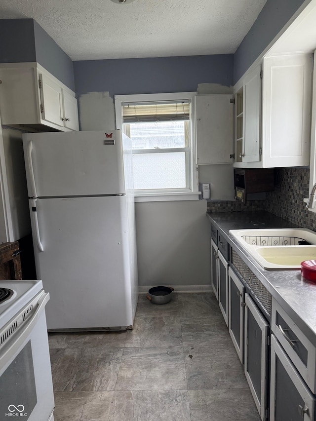1918 14th St, Columbus, IN 47201 - kitchen with white appliances, white cabinetry, tasteful backsplash, and a textured ceiling