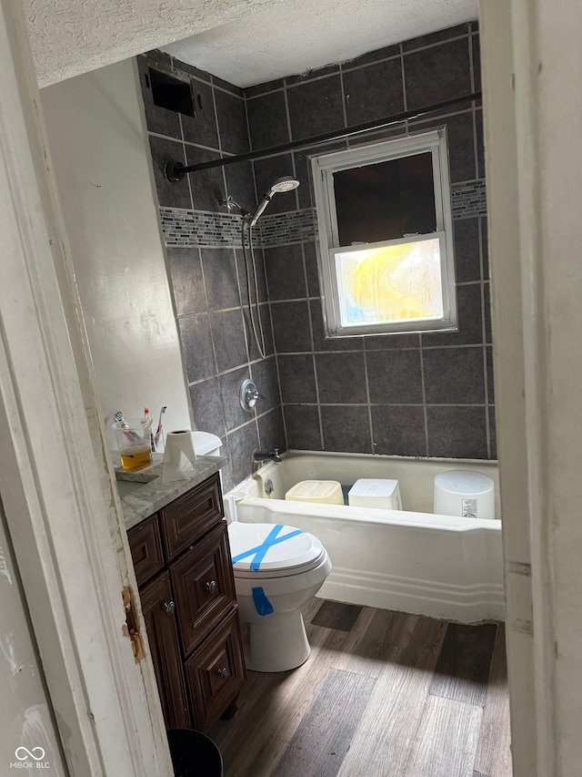 1918 14th St, Columbus, IN 47201 - full bath with wood finished floors, washtub / shower combination, a textured ceiling, and vanity