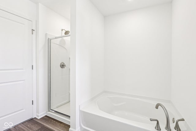 1186 Vera Blvd, Danville, IN 46122 - bathroom with a bath, a stall shower, and wood finished floors