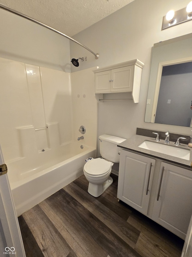 4293 Blue Spruce Ct, Greenwood, IN 46143 - bathroom featuring wood finished floors, shower / tub combination, vanity, and a textured ceiling