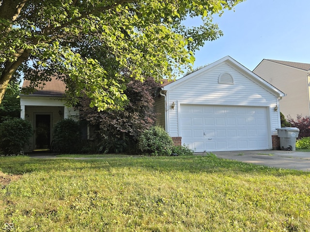 4293 Blue Spruce Ct, Greenwood, IN 46143 - view of front of home with brick siding, concrete driveway, a front yard, and an attached garage