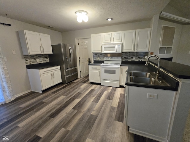 4293 Blue Spruce Ct, Greenwood, IN 46143 - kitchen featuring white appliances, backsplash, dark countertops, white cabinets, and a textured ceiling