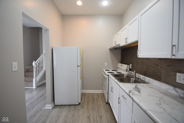 552 Jefferson Ave, Indianapolis, IN 46201 - kitchen featuring white appliances, white cabinets, light wood-type flooring, recessed lighting, and light stone countertops