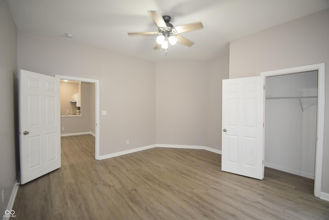 552 Jefferson Ave, Indianapolis, IN 46201 - unfurnished bedroom with wood finished floors, a closet, and ceiling fan