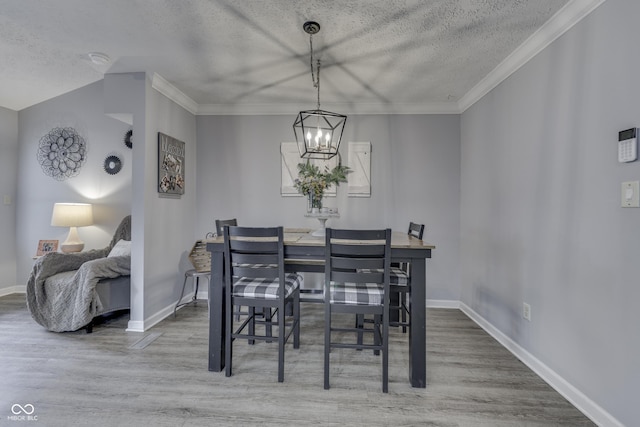 7444 Melanie Ln, Indianapolis, IN 46217 - dining space with a textured ceiling, wood finished floors, a chandelier, and crown molding