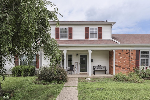 7444 Melanie Ln, Indianapolis, IN 46217 - view of front of house with a front lawn and a porch