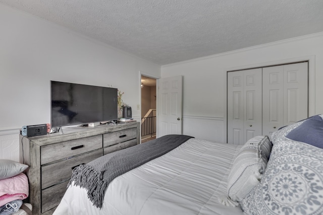 7444 Melanie Ln, Indianapolis, IN 46217 - bedroom with a closet, a textured ceiling, wainscoting, and crown molding