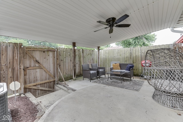 7444 Melanie Ln, Indianapolis, IN 46217 - fenced backyard featuring a patio area, a gate, a ceiling fan, and an outdoor hangout area