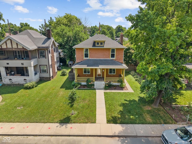3055 N Washington Blvd, Indianapolis, IN 46205 - american foursquare style home with a porch, a front lawn, and a chimney
