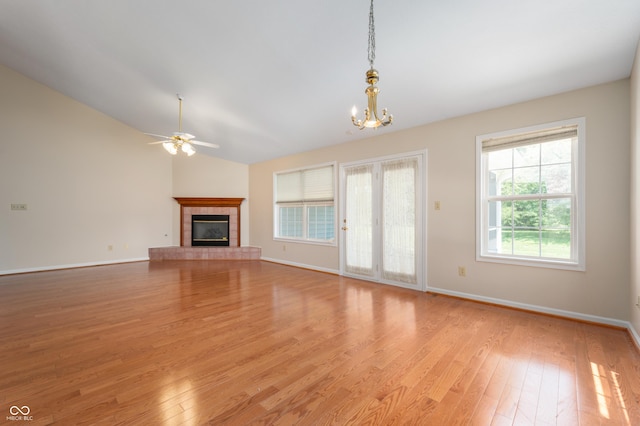 11628 Coastal Way, Indianapolis, IN 46229 - unfurnished living room featuring light wood finished floors, ceiling fan, a fireplace, healthy amount of natural light, and lofted ceiling