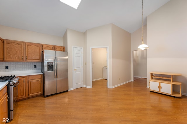11628 Coastal Way, Indianapolis, IN 46229 - kitchen featuring appliances with stainless steel finishes, light wood-style floors, light countertops, decorative backsplash, and brown cabinetry