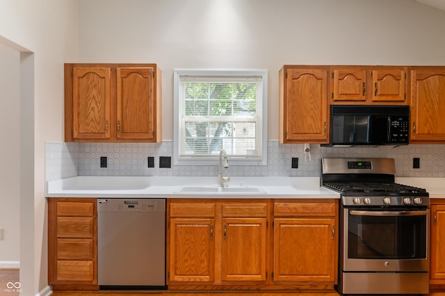 11628 Coastal Way, Indianapolis, IN 46229 - kitchen with appliances with stainless steel finishes, light countertops, brown cabinets, and backsplash