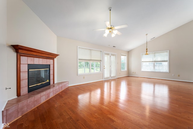 11628 Coastal Way, Indianapolis, IN 46229 - unfurnished living room with vaulted ceiling, wood finished floors, a tile fireplace, and ceiling fan