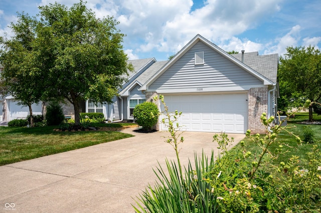 11628 Coastal Way, Indianapolis, IN 46229 - view of front of home featuring concrete driveway, brick siding, an attached garage, a front lawn, and roof with shingles