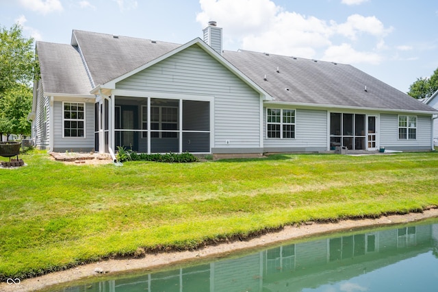 11628 Coastal Way, Indianapolis, IN 46229 - back of property featuring a sunroom, a shingled roof, a chimney, and a yard