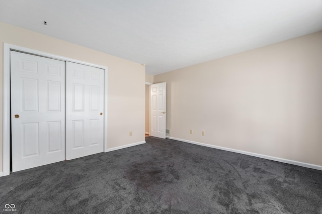 11628 Coastal Way, Indianapolis, IN 46229 - unfurnished bedroom featuring dark colored carpet and a closet