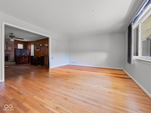 5530 Skyridge Dr, Indianapolis, IN 46250 - unfurnished living room featuring wood finished floors, ceiling fan, and a fireplace