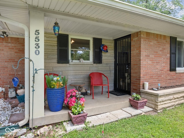5530 Skyridge Dr, Indianapolis, IN 46250 - entrance to property with a porch and brick siding