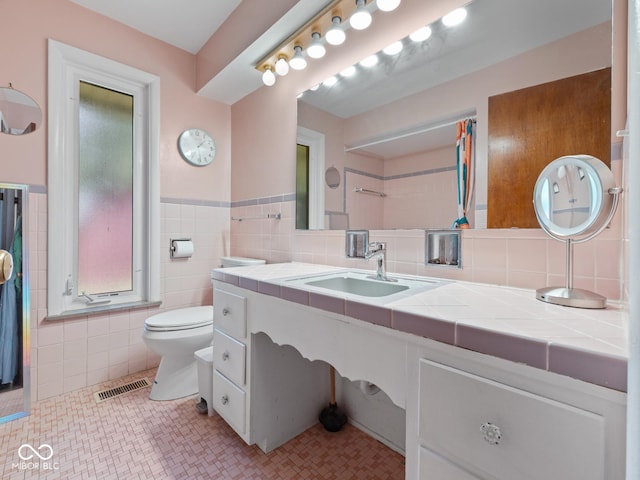 5530 Skyridge Dr, Indianapolis, IN 46250 - bathroom with tile walls, vanity, and a wainscoted wall