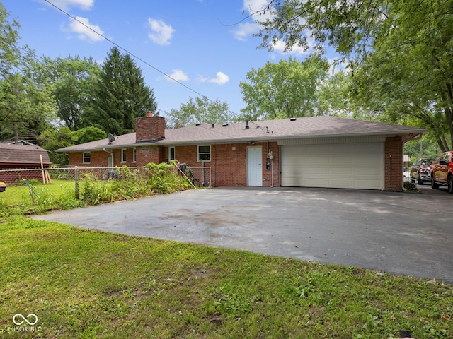 5530 Skyridge Dr, Indianapolis, IN 46250 - single story home with asphalt driveway, a garage, and brick siding