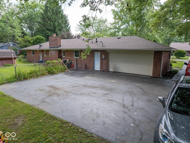 5530 Skyridge Dr, Indianapolis, IN 46250 - single story home featuring driveway, brick siding, a chimney, a garage, and roof with shingles