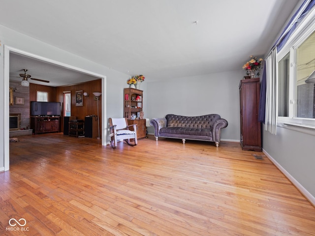 5530 Skyridge Dr, Indianapolis, IN 46250 - living area with light wood-style floors, a ceiling fan, and a large fireplace