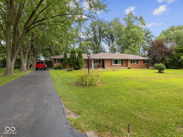 5530 Skyridge Dr, Indianapolis, IN 46250 - single story home with asphalt driveway, brick siding, and a front lawn