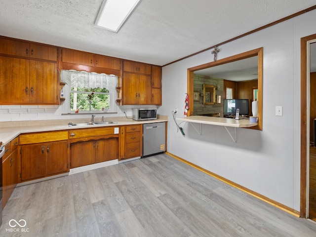 5530 Skyridge Dr, Indianapolis, IN 46250 - kitchen with stainless steel appliances, a textured ceiling, light countertops, brown cabinetry, and light wood-style flooring