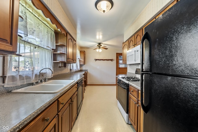 2635 15th St, Columbus, IN 47201 - kitchen with freestanding refrigerator, white microwave, range with gas cooktop, dishwashing machine, and brown cabinets