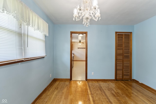 2635 15th St, Columbus, IN 47201 - unfurnished bedroom with light wood-style flooring, a closet, and a chandelier