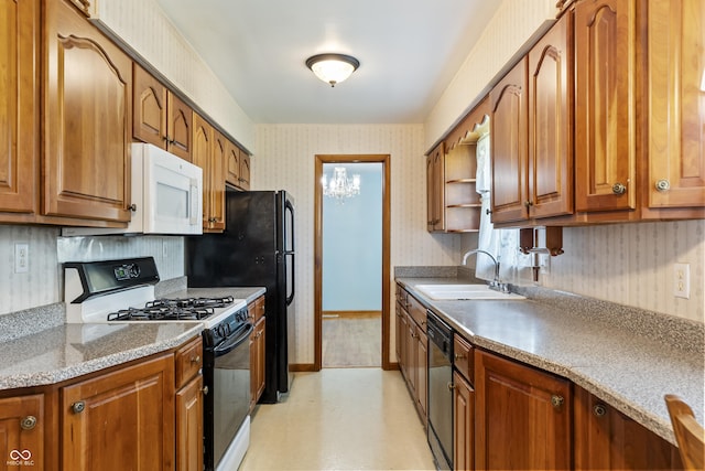 2635 15th St, Columbus, IN 47201 - kitchen with black range with gas stovetop, white microwave, wallpapered walls, dishwashing machine, and brown cabinetry