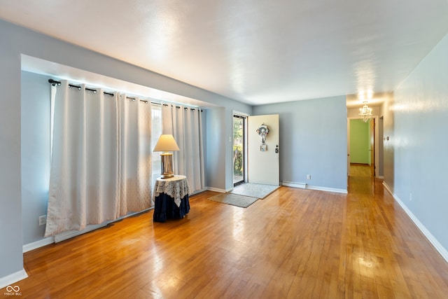 2635 15th St, Columbus, IN 47201 - entryway with light wood-style flooring and a chandelier