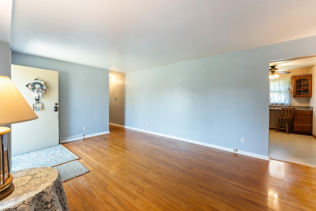 2635 15th St, Columbus, IN 47201 - living area with baseboard heating, wood finished floors, and ceiling fan