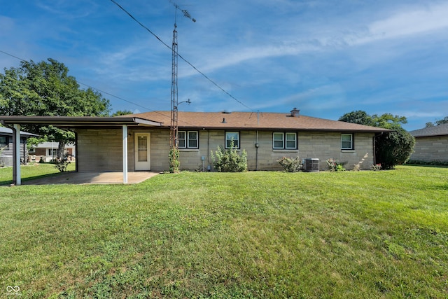 2635 15th St, Columbus, IN 47201 - back of property with a yard, an attached carport, and concrete block siding